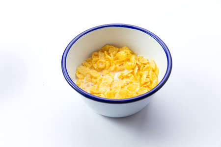 Breakfast cereals. With milk. In a plate. Isolated on white. Selective focus.の写真素材