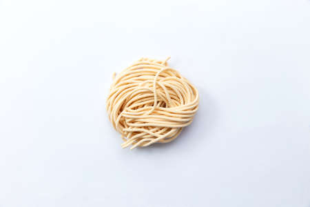 Dry homemade pasta. Isolated on white. Selective focus.の写真素材