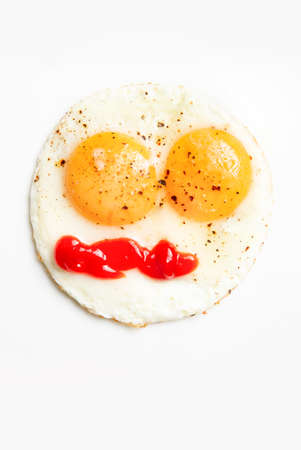 Fried eggs in the form of a smiley. On white background.の写真素材