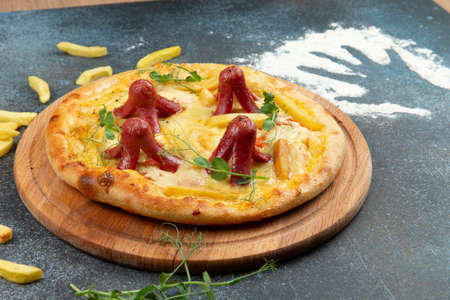 Homemade pizza with sausages. On a gray background. Selective focus.