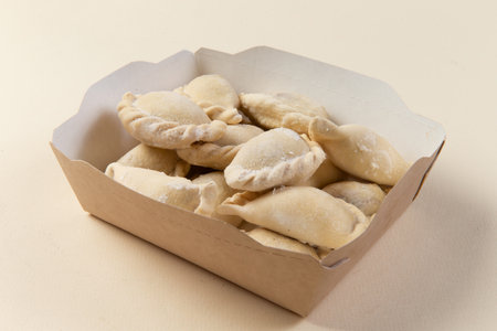 Raw dumplings in a package. Vareniki. On a light background. selective focus.の写真素材