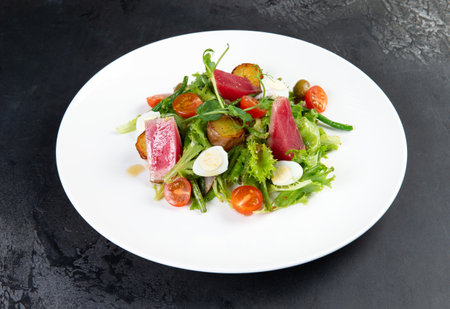 Salad with tuna, tomatoes and herbs. selective focus.の写真素材