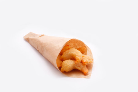 Fried shrimp wrapped in paper. isolated on white. selective focus.の写真素材
