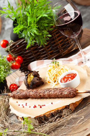 Beef kebab on a skewer. On a wooden tray. selective focus.の写真素材