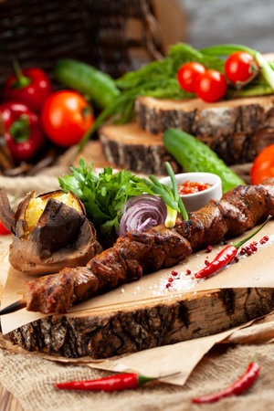 Beef skewers on a skewer. On a wooden tray. selective focus.の写真素材