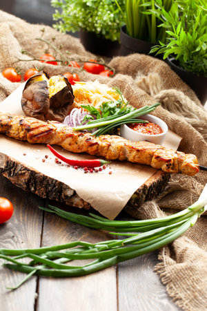 Chicken skewers on a skewer. On a wooden tray. selective focus.の写真素材