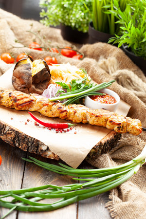 Chicken skewers on a skewer. On a wooden tray. selective focus.の写真素材