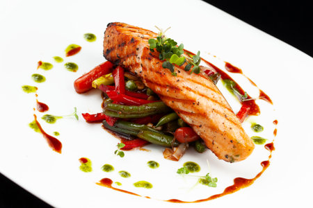 Salmon steak and vegetables in a plate. selective focus.の写真素材