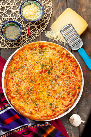 Pizza with cheese on a wooden table. view from above.の写真素材