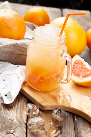 Glass with lemonade. On a wooden table. selective focus.の写真素材