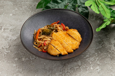 Fried meat and wok noodles in a plate. on a gray background. selective focus.の写真素材