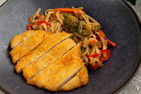Fried meat and wok noodles in a plate. on a gray background. selective focus.の写真素材