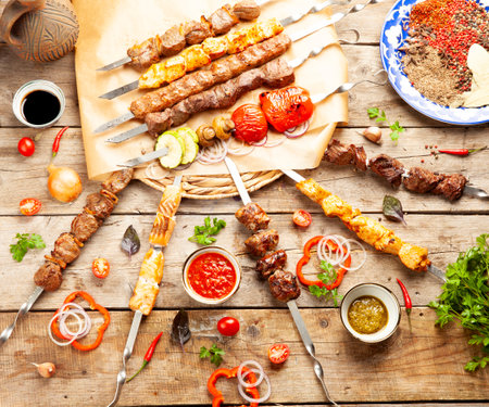 Mix of shish kebabs on skewers. on a wooden table. selective focus.の写真素材