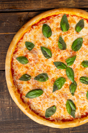 Pizza with spinach and cheese. On a wooden table. view from above.の写真素材