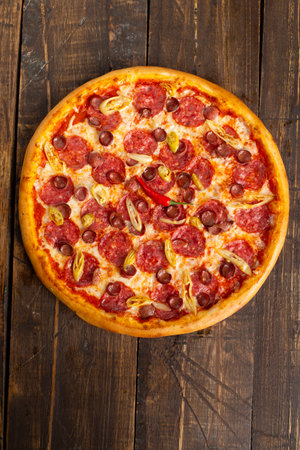 Pepperoni and sausage pizza. On a wooden table. view from above.の写真素材