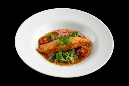 Salmon steak and sauce in a plate on a black background. selective focus.の写真素材