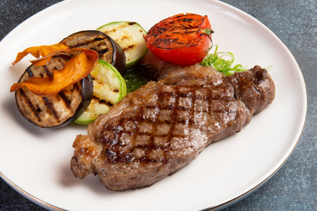 Striploin steak and grilled vegetables in a plate. selective focus.の写真素材