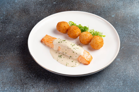 Salmon steak and cheese balls in a plate. selective focus.の写真素材