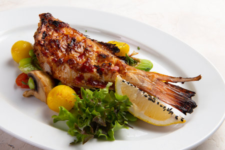 Grilled perch in a bowl. On a light background. selective focus.