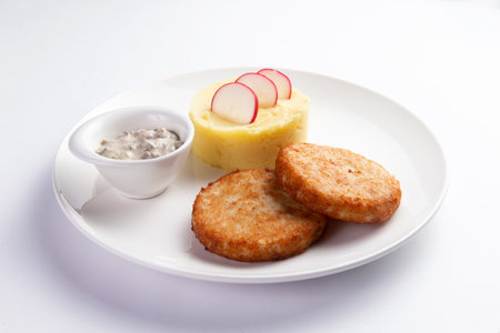 Cutlets and mashed potatoes in a plate. On a light background. selective focus.の写真素材