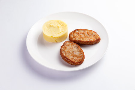 Cutlets and mashed potatoes in a plate. On a light background. selective focus.の写真素材