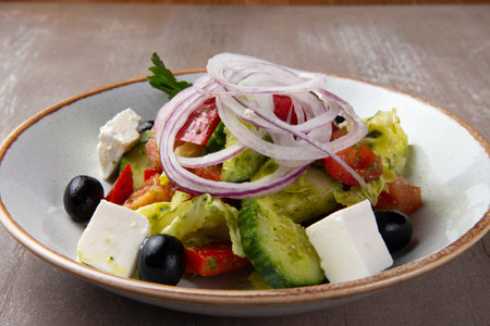 Greek salad in a plate on a brown background. selective focus.の写真素材