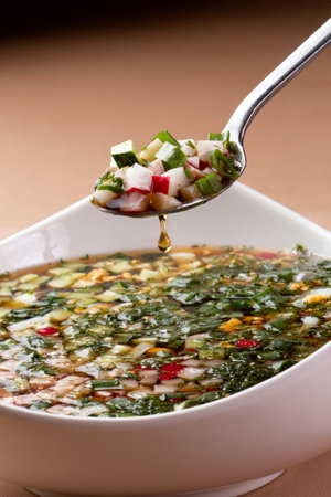 Okroshka. Traditional cold soup. On a brown background. selective focus.の写真素材