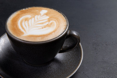 Cup of cappuccino on a dark background. Selective focus.の写真素材