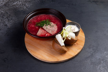 Traditional borscht soup with rye bread and lard. On a dark background.の写真素材