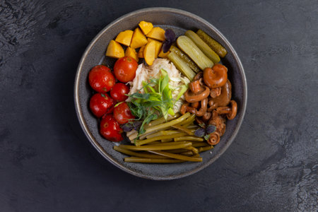 Pickled vegetables in a plate. On a dark background.の写真素材
