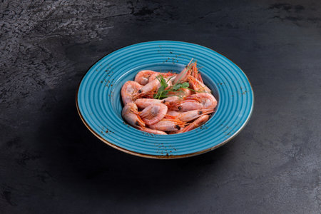 Cooked shrimp in a plate. On a dark background.の写真素材
