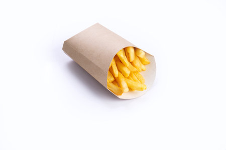 French fries in a cardboard cup. Isolated on white.の写真素材
