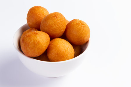 Fried cheese balls in a plate. On a light background. Selective focus.