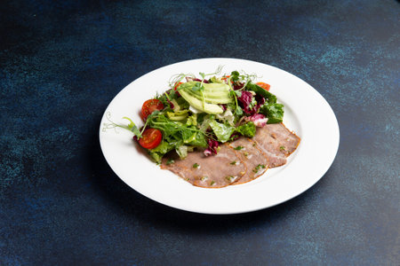 Beef and salad in a plate on a dark background. Selective focus.の写真素材