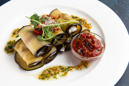 Eggplant rolls with cheese in a plate on a dark background. Selective focus.の写真素材