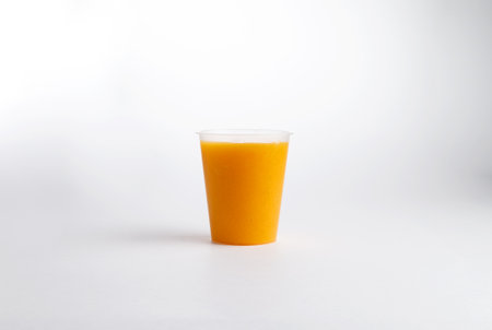Freshly squeezed orange juice in a glass. on a white background.の写真素材