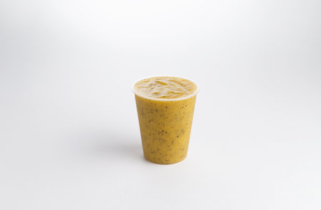 Fruit smoothie in a plastic glass. on a white background. Selective focus.の写真素材