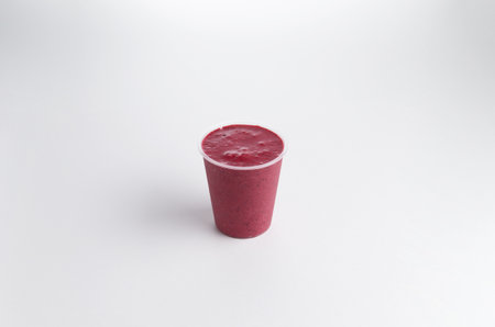 Smoothie in a plastic cup. On a white background. Selective focus.の写真素材