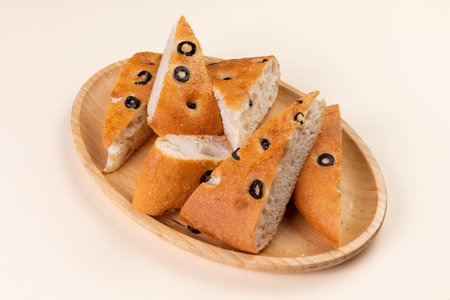 Ciabatta with olives on a wooden plate.の写真素材