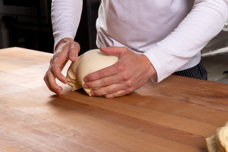Pastry chef kneads puff pastry. Selective focus.の写真素材