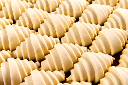 Puff pastry croissants ready to bake. Selective focus.の写真素材