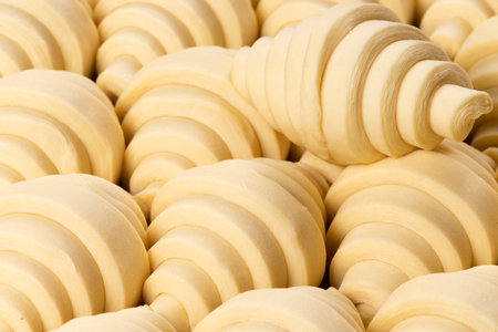 Puff pastry croissants ready to bake. Selective focus.の写真素材