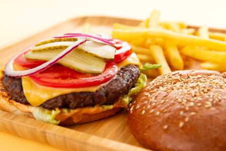 Perfect hamburger, classic burger, american cheeseburger with cheese and fries. Selective focus.の写真素材