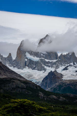 Rocky snowy mountain peaks with the sun rising behind and red clouds. Fitz Roy in Argentinaの写真素材