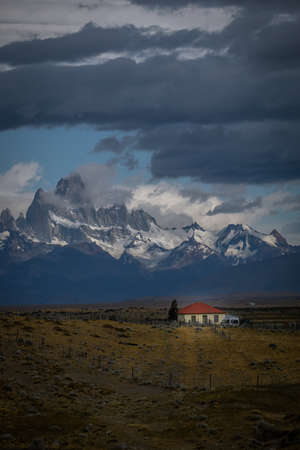 Rocky snowy mountain peaks with the sun rising behind and red clouds. Fitz Roy in Argentinaの写真素材