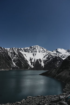Impressive vertical photo of the Embalse El Yeso, located in San Jose de Maipo known as El Cajon del Maipo in the Andes Mountains, Chilean Patagoniaの写真素材
