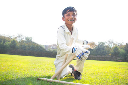a boy wicket keeper stumping during cricket gameの写真素材