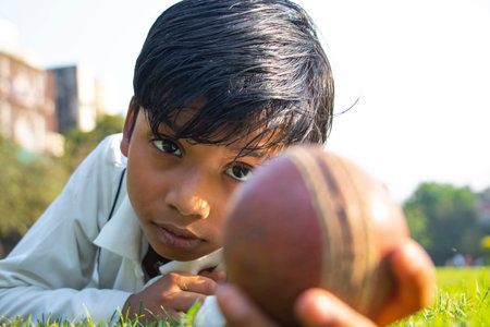 Boy catching cricket ball in the groundの写真素材