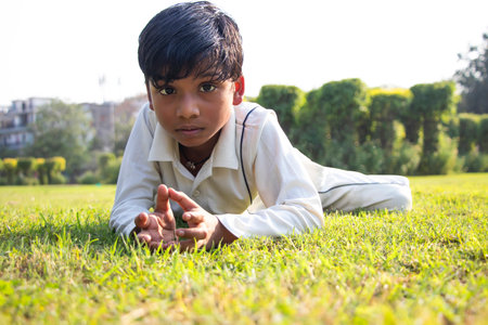 a boy lying on the ground a during cricket gameの写真素材