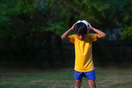 Portrait Of A Young Boy  throwing football